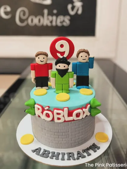 A Roblox-themed cake featuring custom fondant figures and the iconic game logo. This design is perfect for celebrating a gamer's 9th birthday.