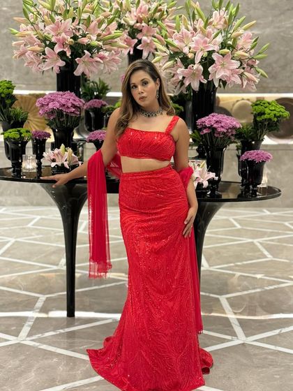 Dressed in a stunning red lehenga, ready for a grand celebration. This look is perfect for a Sangeet or wedding reception where you want to make a bold and beautiful statement.