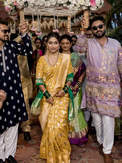 The bride making her grand entrance under a phoolon ki chadar.