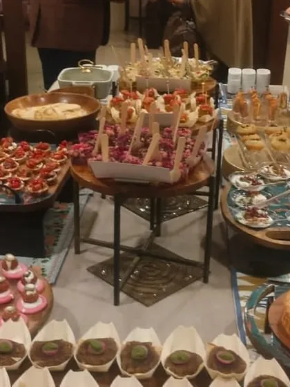 A high tea experience where every dish is a masterpiece. This image shows a table laden with delights like beetroot falafel and kala channa kebab.