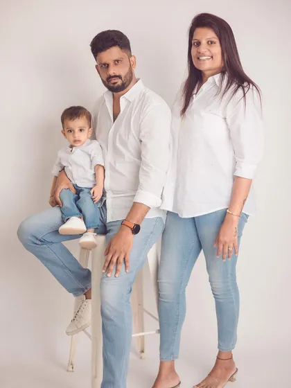 A classic family portrait that feels timeless. Coordinated outfits like simple white shirts and blue denim create a clean, cohesive look that keeps the focus on your family's connection.