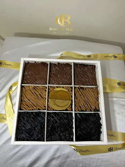 My 100% eggless brownie boxes are a bestseller for every occasion. This Rakhi special box contains nine decadent brownies in three assorted flavours: rich Truffle, creamy Nutella, and spiced Lotus Biscoff, all presented in a premium gift box.