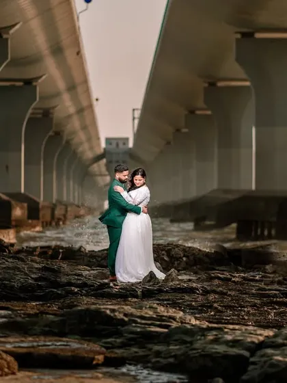 Finding beauty in unexpected urban locations. This portrait was taken under a Mumbai sea link bridge, using the massive pillars to create a powerful, industrial-style frame for the couple.
