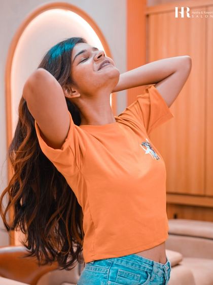 A happy client feeling her new hair. The joy and confidence after a transformation is what it's all about.