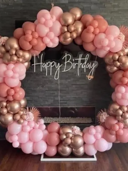 A close-up of the elegant dusty rose and rose gold balloon ring. The different sizes and shades of balloons create a beautiful texture and depth.