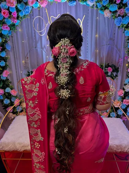 The full view of this stunning "Rapunzel" braid against the beautiful event decor. It was a perfect hairstyle for a special day.