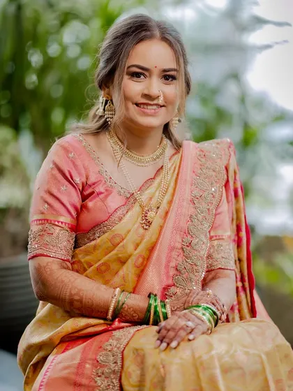 A beautiful, happy portrait. Her glowing skin and bright smile are the highlights of this look, enhanced by soft, elegant makeup.