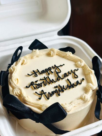 Another angle of our black bow bento cake, showing how the ribbons are tied perfectly around the cake. It's all in the details.