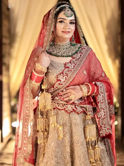 A portrait of bridal elegance. The makeup is kept classic with a red lip and defined eyes to complement her traditional attire.