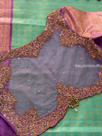 A purple blouse with a sheer, sequined back panel.
