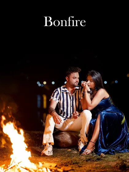 A cozy and intimate bonfire shoot by the water. The warm glow of the fire creates a romantic atmosphere, perfect for a relaxed and heartfelt pre-wedding session.