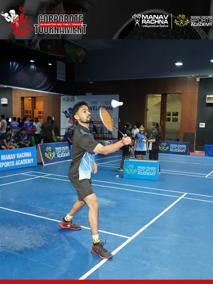 A player in full flight during a badminton match. We capture the dynamic action of our corporate tournaments, highlighting the passion and energy of the participants.