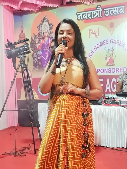 On stage at a Navratri Utsav, with the DJ in the background. I was there to host the night, announce prizes, and keep the garba lovers energized.