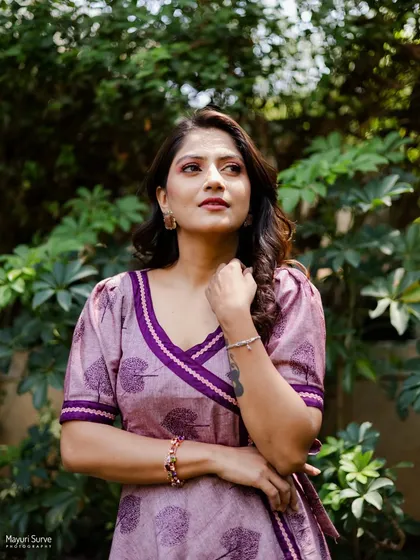 A poised and confident outdoor portrait. The actress's thoughtful expression and strong pose create a sophisticated and professional look.