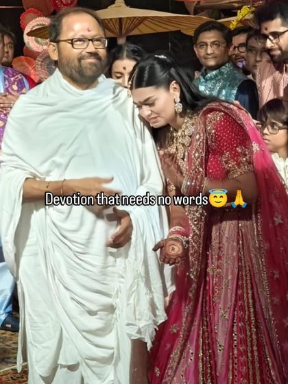 A moment of pure devotion. In Vietnam, far from home, the bride seeks blessings from her Guruji before her wedding rituals begin, a testament to her faith.