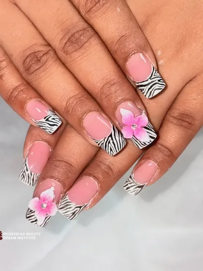 A full view of the zebra print French tips with 3D pink flowers, showing how the design looks across the entire hand.