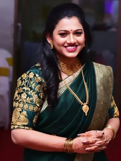 An elegant and happy client ready for her engagement. I created this look with a focus on soft, defined eyes, a beautiful berry lip color, and a simple half-up hairstyle that complements her traditional Marathi attire.