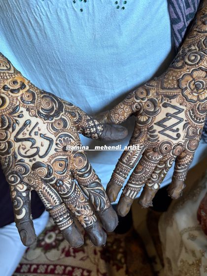 A close-up of the palms from the previous design, showing the 'Z' and 'Z' initials and the name 'Zikra' in Arabic.