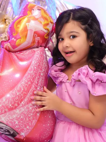 A happy, candid moment during a child's birthday photoshoot. These spontaneous smiles are what we live to capture.