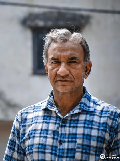 A simple, straightforward portrait of a man I met. The checkered shirt and the neutral background keep the focus entirely on his face and his calm demeanor.