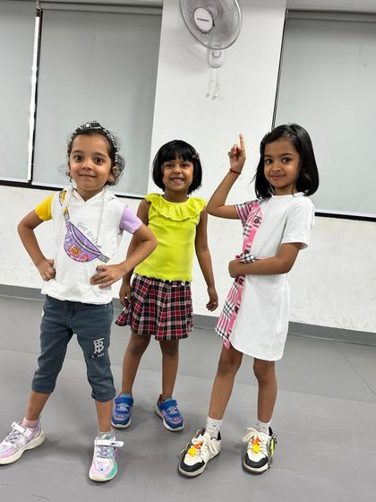 Three of our little divas posing for the camera. Their style and confidence are already off the charts! This is what our kids' classes are all about.