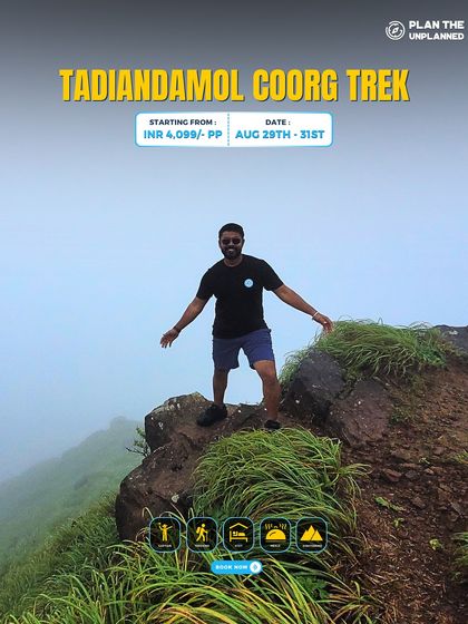 A trekker poses on a rocky outcrop during the Tadiandamol trek in Coorg. This trek takes you through coffee estates and grasslands to the highest peak in the region.