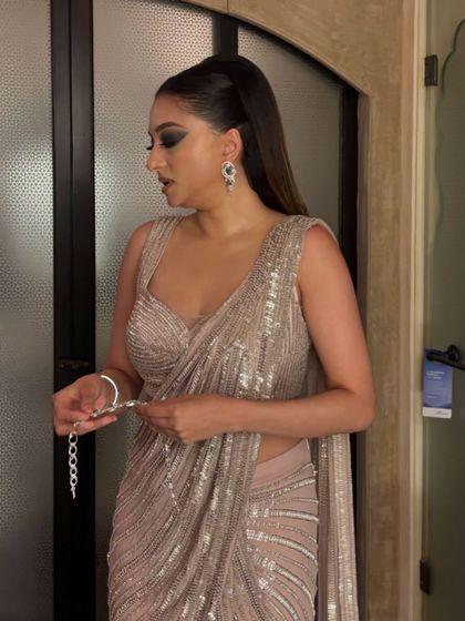 A side view of the sleek ponytail with a twist. The hair is kept smooth and shiny, with a beautiful wave at the end, perfect for a sophisticated evening event.