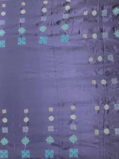 The full view of the contemporary Kasuti saree. The gradient-like arrangement of the motifs in shades of blue and silver creates a sophisticated and unique look.