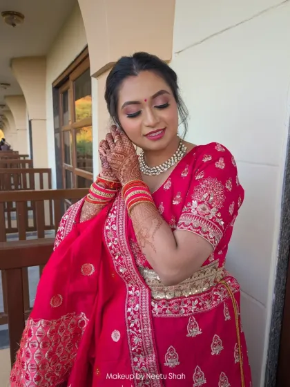 A chic and sleek look for a wedding event. The makeup is subtle yet defined, perfectly complementing her bright pink lehenga and diamond jewelry.