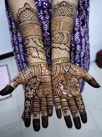 A complete view of the henna I did for the bride's sister. Both hands are adorned with matching peacock designs and dense patterns, fit for a wedding celebration.