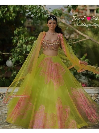 A full-length shot of this vibrant neon lehenga look. The simple diamond jewellery ensures that the focus remains on the stunning colours of the outfit while adding a touch of elegance.
