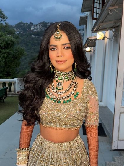The bride without her veil, showing off her beautiful, voluminous waves against the scenic mountain backdrop.