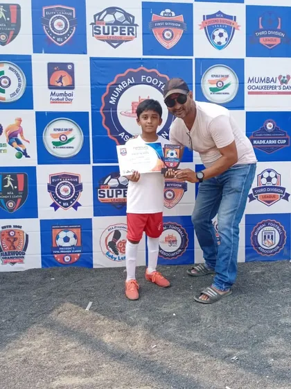 A coach congratulating one of our young stars on his individual award, highlighting our supportive environment.