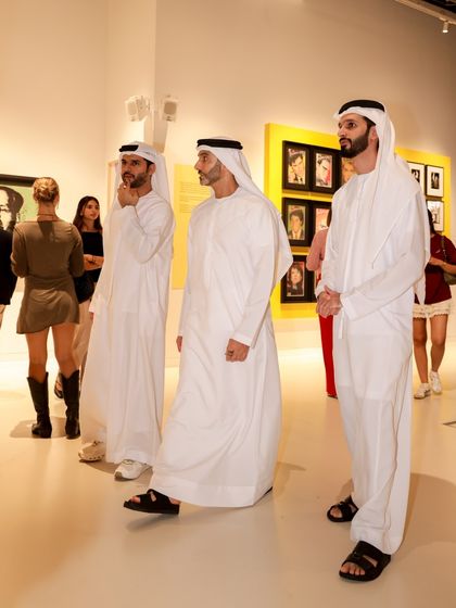 Guests in traditional Emirati dress enjoying the Andy Warhol exhibition I played at in Dubai. I am comfortable and experienced in performing for diverse, international audiences in formal settings.