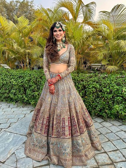 A full-length shot of the bride in her magnificent lehenga. The makeup ties the entire look together, from the jewelry to the outfit.