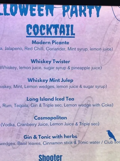 Our custom Halloween cocktail menu, with spooky-themed names and designs to match the party's vibe.