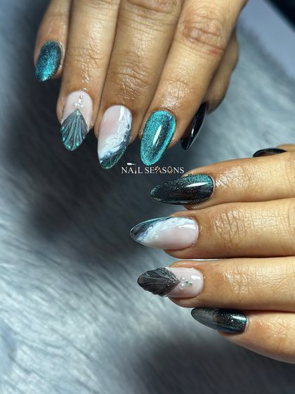 The cat eye effect on the teal polish looks like a shimmering mermaid tail.