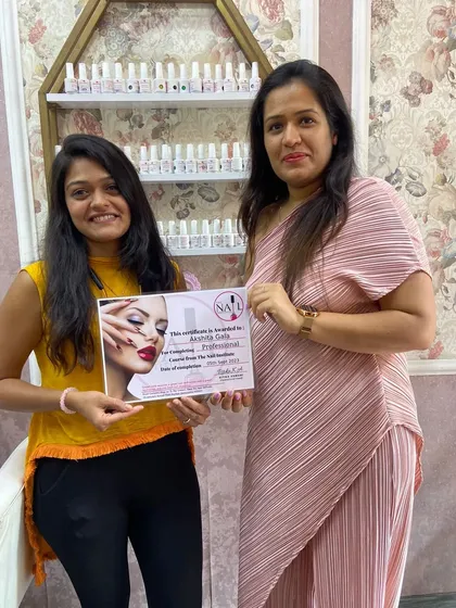 Akshita proudly holds her certificate after finishing the professional course. Her journey as a nail artist is just beginning.
