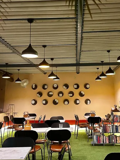 This wall at Café Quaint is a great example of upcycled art. We repurposed old dinner plates, painting and arranging them in a pattern that reflects the local architecture, turning something old into a meaningful and sustainable art installation.