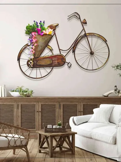 We love creating pieces that add a touch of personality and charm. This large, cycle-shaped metal wall decor with an antique finish and a built-in flower basket is a whimsical and nostalgic statement piece, perfect for adding character to a rustic or eclectic interior.