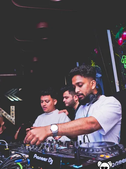 A focused moment during a B2B set. Here, I am completely tuned into the music and the crowd, making sure every mix is seamless and powerful.