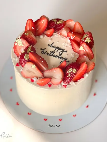 A seasonal favorite, this Vanilla Strawberry cake is topped with fresh strawberries, edible gold leaf, and tiny sugar pearls. It's available as a celebration cake or a smaller bento cake.