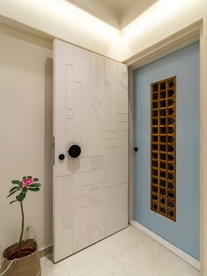 The entrance sets the tone for the entire home. We designed this modern, minimalist main door and safety door combination to be a piece of art in itself, offering a unique and welcoming first impression.