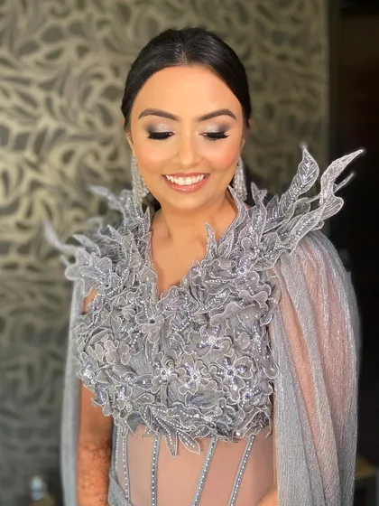 A close-up of Bansi's reception makeup, showing the soft smokey eye and her radiant smile.