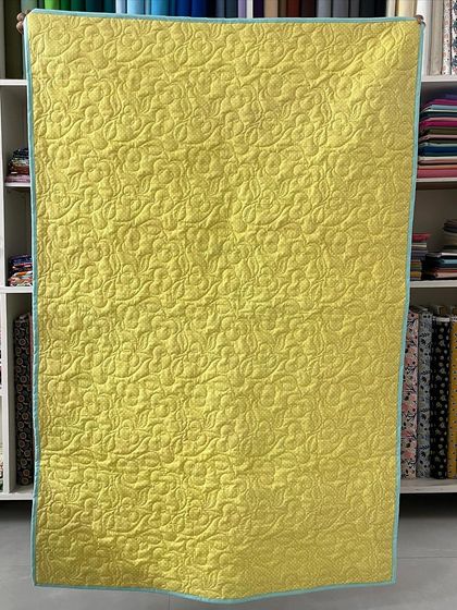 The bright yellow backing fabric for the baby quilt.