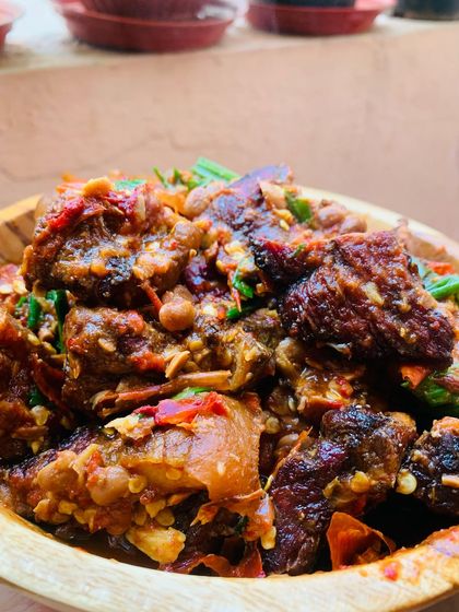 Close up of the smoked pork with axone. You can see the chunks of fermented soya beans mixed in with the pork.