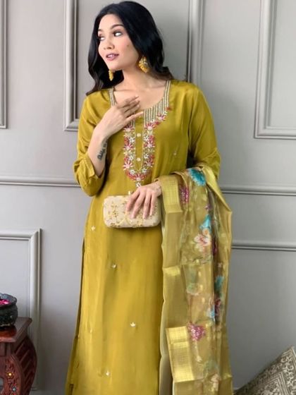 A beautiful mustard viscose chanderi kurta set. The thread embroidery on the neckline and the printed dupatta create a look that's both traditional and trendy.