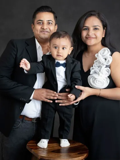 This little gentleman is standing tall for his family portrait. A one year milestone session is the perfect time to capture them taking their first steps.