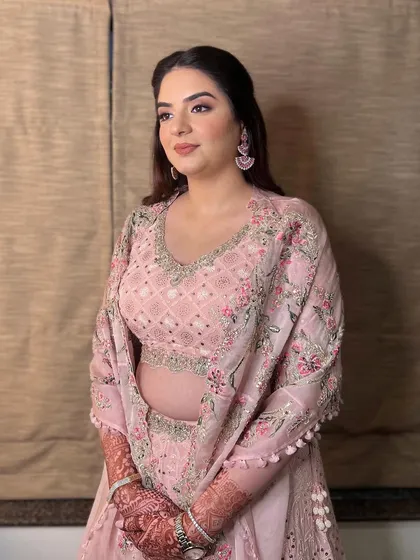 Esha looking elegant and poised for her Roka. The makeup is soft and sophisticated, with a focus on flawless skin and defined features.