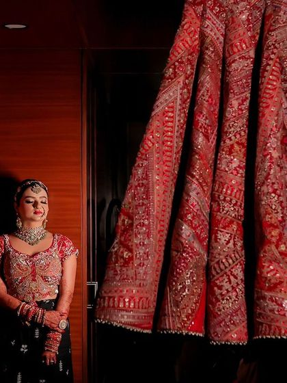 An artistic shot of the bride with her wedding lehenga. The makeup is subtle yet impactful, designed to make her look and feel her absolute best.